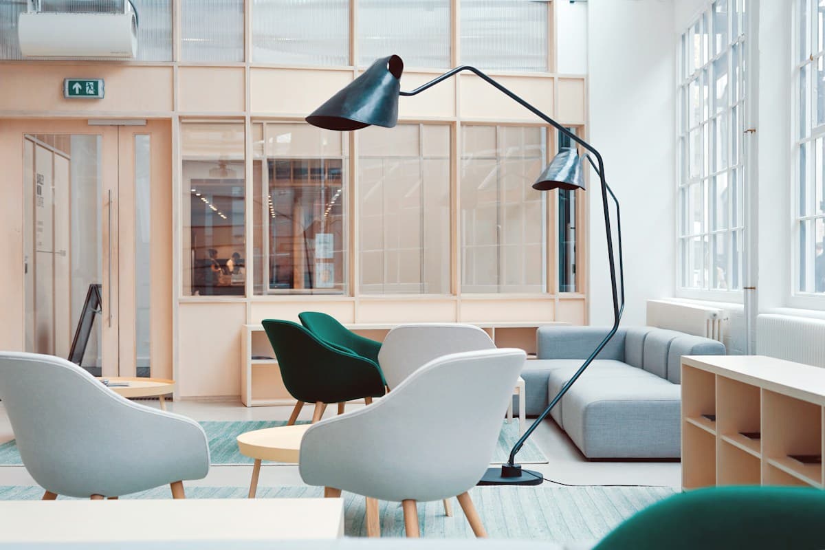 A bright creative workspace with shared tables and greenery